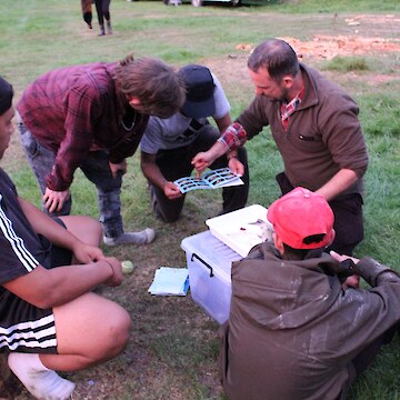 Matt Dale dissecting a trout and showing tauira.