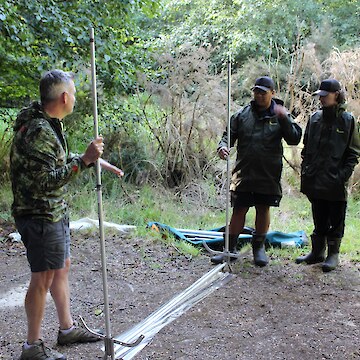 Ian explaining how to set up the Harp traps. The tauira helping to put these together and place them.