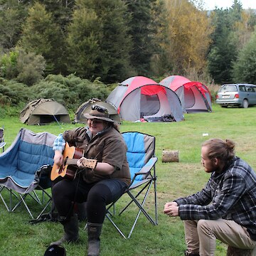 Kelsi Hayes entertaining the rōpū with her amazing guitar and waiata skills, with on-looker Luka Finn.