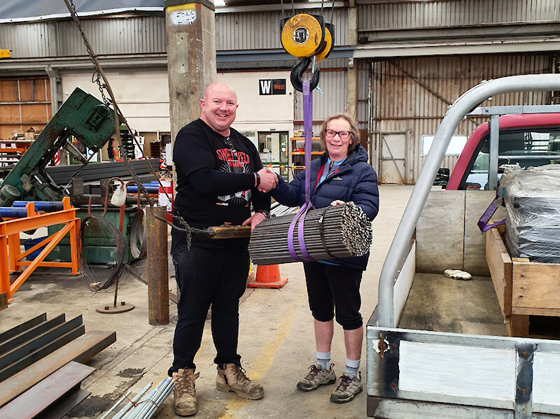Donation of Reo Stakes and Warratahs from Fletcher Steel’s Mike Mulligan to Lois Bishop from the Hokonui Tramping Club.